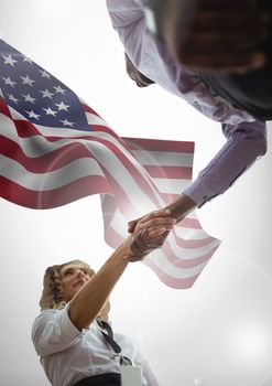 Digital composite of people shaking their hands against american flag
