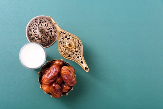 Ramadan, Dates in golden bowl, Milk, arabian Aladdin golden lamp vintage style on black green background