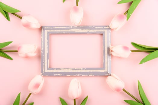 Happy Women's Day, Mother's Day concept. top view flat lay photo frame and Tulip flower on pink background, copy space for your text