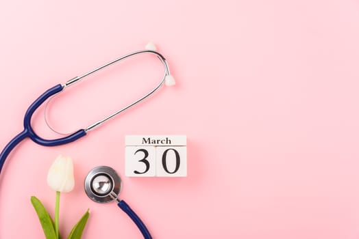 Doctor's Day concept, flat lay top view, equipment medical red heart and stethoscope on pink background, care patient in hospital with copy space for text