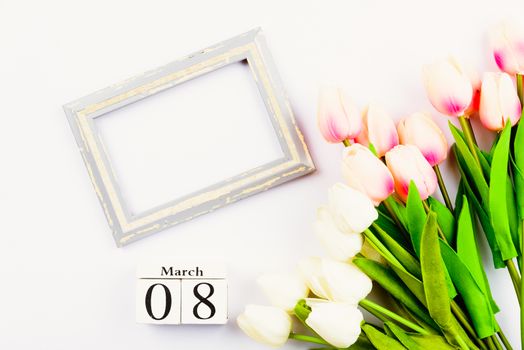 Happy Women's Day, Mother's Day and Valentine's Day concept. top view flat lay Tulip flower and photo frame on white background, copy space for your text