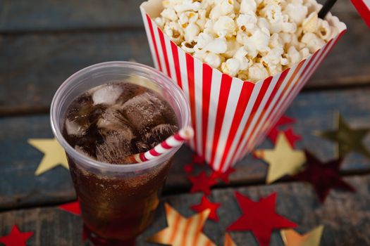 Close-up of popcorn and cold drink with 4th july theme