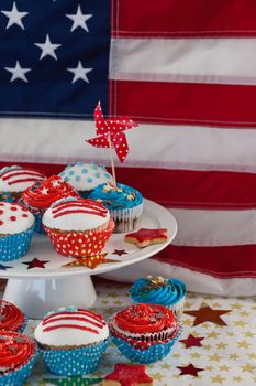 Decorated cupcakes with 4th july theme against American flag