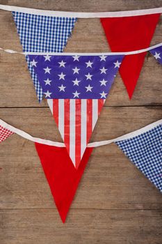 Bunting flags arranged on wooden table with 4th July theme