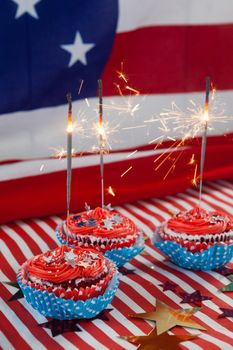 Burning sparkler on decorated cupcakes with 4th july theme