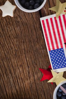 American flag and star shape decoration arranged on wooden table with 4th July theme