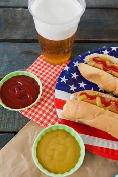Hot dog served on plate with french fries with 4th july theme