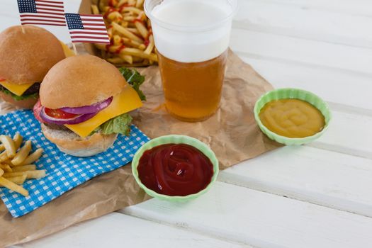 Drink and snacks decorated with 4th july theme on wooden table