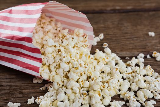 Close-up of spilled popcorn on wooden table with 4th july theme