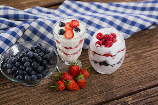 Close-up of fruit ice cream on wooden table with 4th july theme