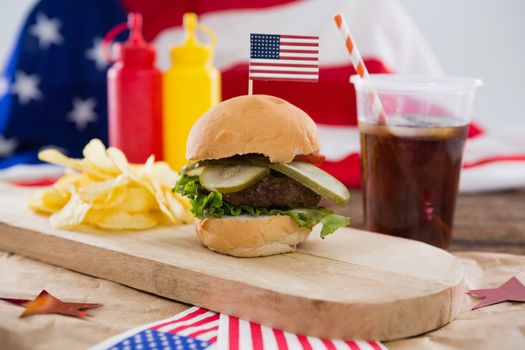 Food and cold drink decorated with 4th july theme on wooden table