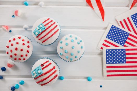 Cupcakes decorated with 4th july theme on wooden table