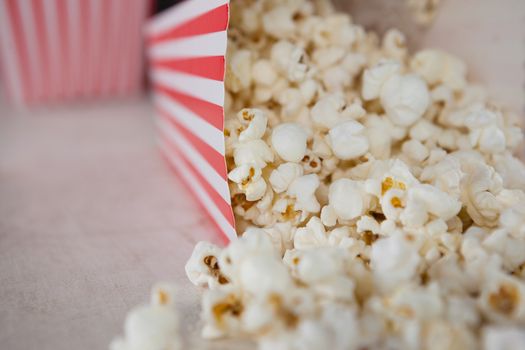 Close-up of scattered popcorn on wooden table with 4th july theme