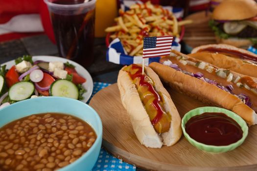 Snacks and food arranged on wooden table with 4th july theme