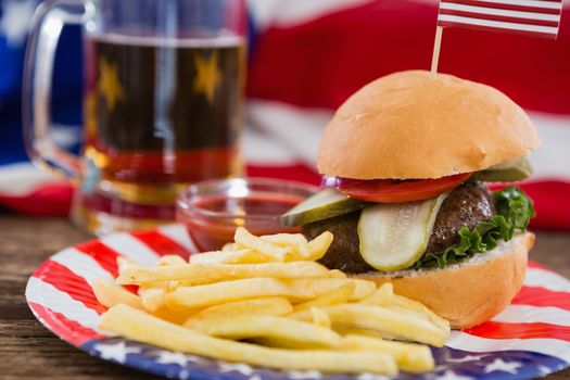Close-up of burger on wooden table with 4th july theme