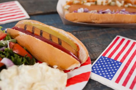 Close-up of hot dog with 4th july theme on wooden table