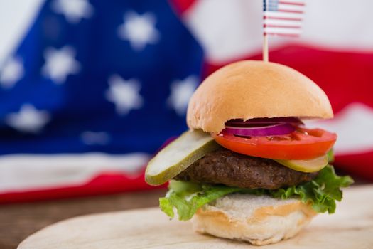 Close-up of burger on wooden table with 4th july theme