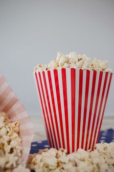 Scattered popcorn against white background with 4th july theme