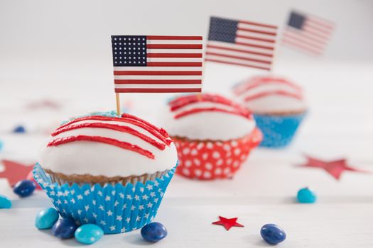 Close-up of cupcakes decorated with 4th july theme on wooden table