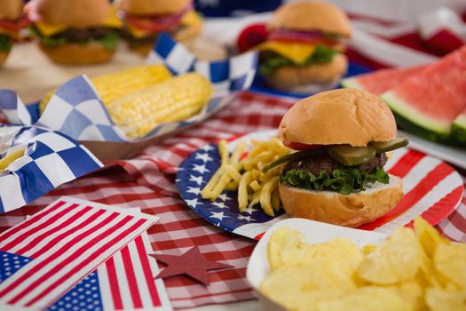Burger and potato chips on plate with 4th July theme