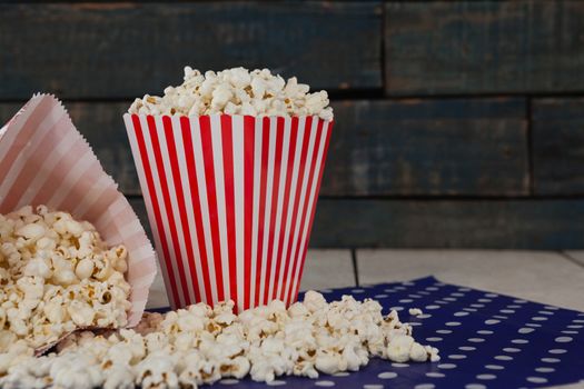 Close-up of scattered popcorn on wooden table with 4th july theme