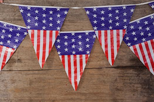 Bunting flags arranged on wooden table with 4th July theme