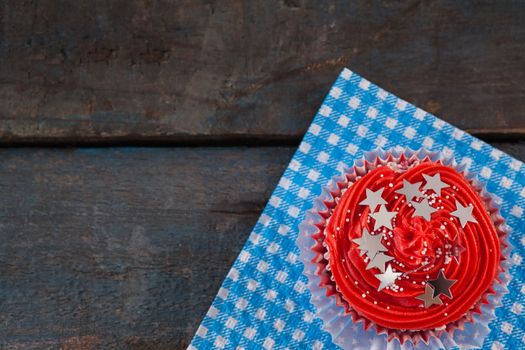 Decorated cupcake with 4th july theme on blue napkin
