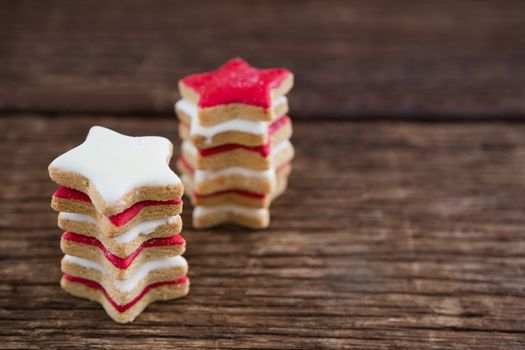 Red and white sugar cookies stacked on wooden table for 4th of July