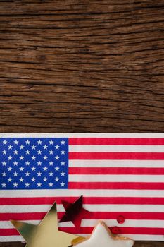 American flag and star shape decoration arranged on wooden table with 4th July theme