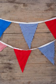 Bunting flags arranged on wooden table with 4th July theme