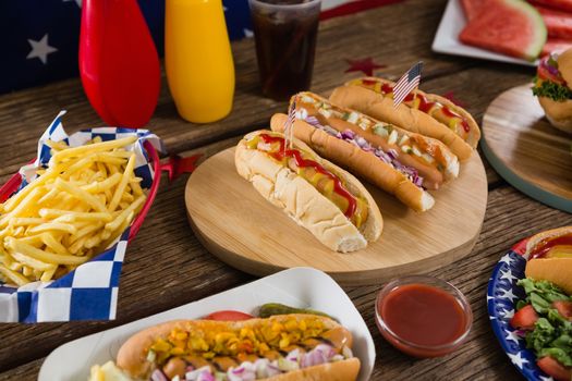 Close-up of hot dogs on wooden table with 4th july theme