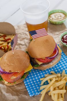Drink and snacks decorated with 4th july theme on wooden table