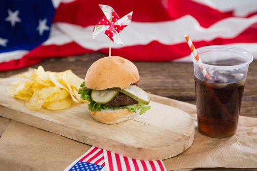 Burger and cold drink on wooden board with 4th july theme