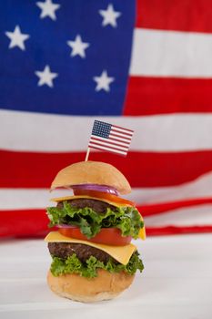 Hamburger with 4th july theme against American flag