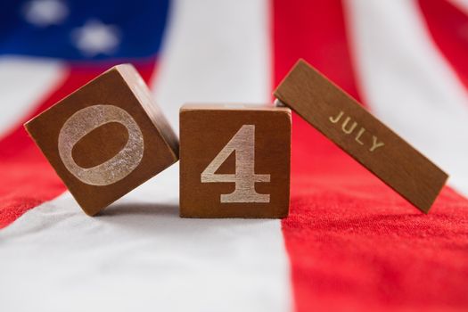 Close-up of date blocks on American flag with 4th july theme