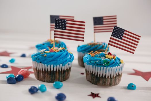 Cupcakes decorated with 4th july theme on wooden table