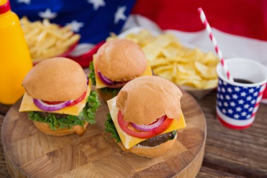 Close-up of burgers on wooden table with 4th july theme