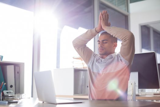 Male executive doing yoga in office