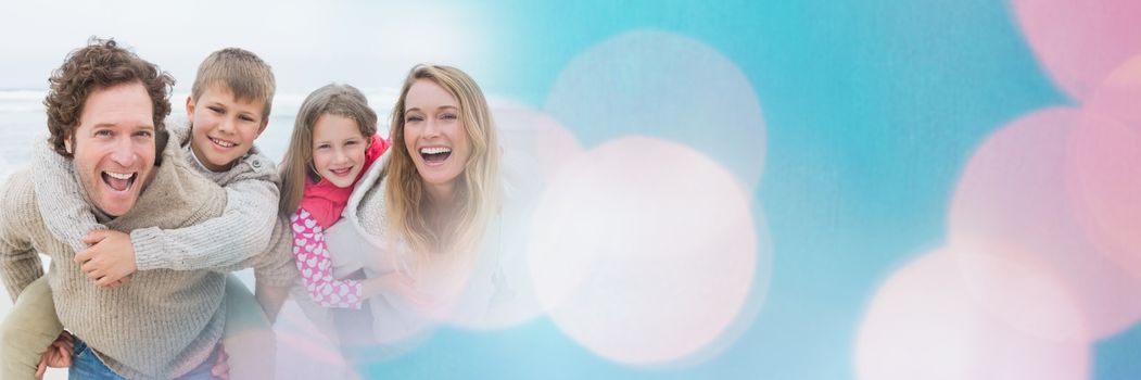 Digital composite of Family at beach doing piggy back with blue and pink bokeh transition