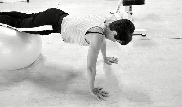 Mature female beauty working out inside a health club.