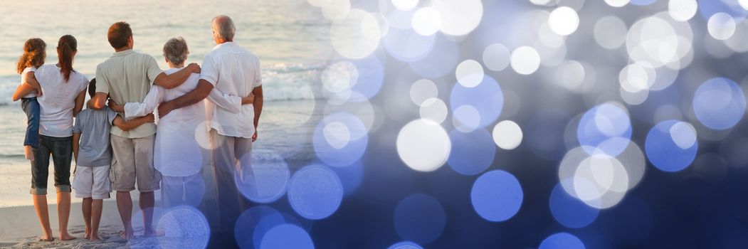 Digital composite of Back of family at beach with blue bokeh transition