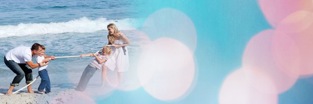 Digital composite of Family playing tug of war at beach with blue and pink bokeh transition