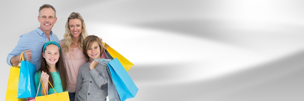 Digital composite of Family with shopping bags against blurry grey abstract background