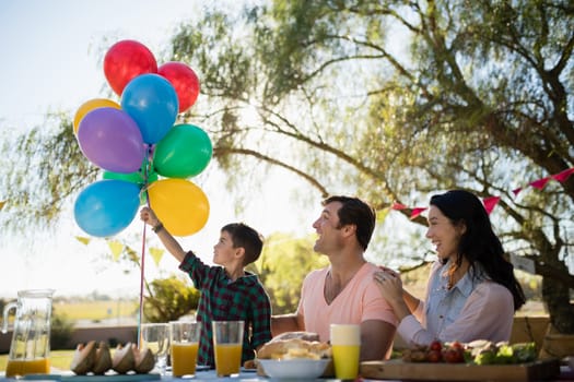 Happy family enjoying together in the park on a sunny day