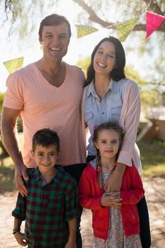 Portrait of happy family enjoying together in the park on a sunny day