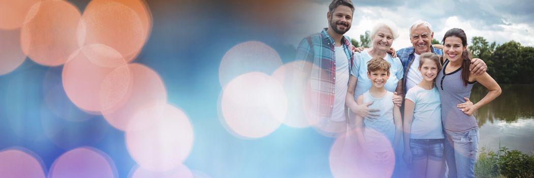 Digital composite of Family smiling with blue orange bokeh transition