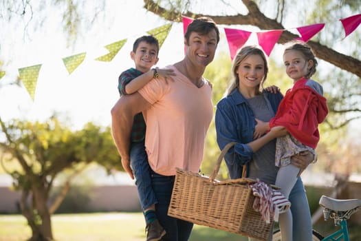 Portrait of happy family enjoying together in the park on a sunny day