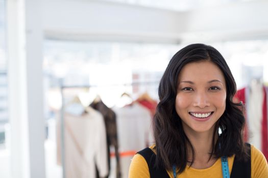 Portrait of smiling fashion designer in office