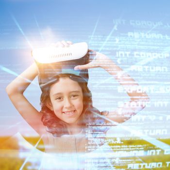 Portrait of smiling girl wearing virtual reality glasses against flock of bird flying over field
