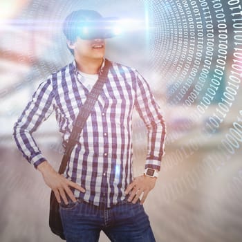 Young man with hand on hop wearing virtual reality simulator glasses against spiral of shiny binary code